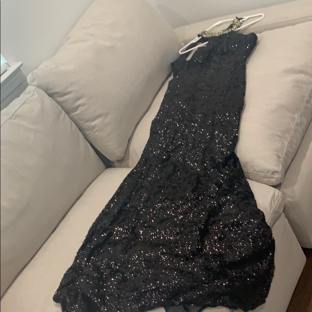 A beautifully studded sequence long gown .
